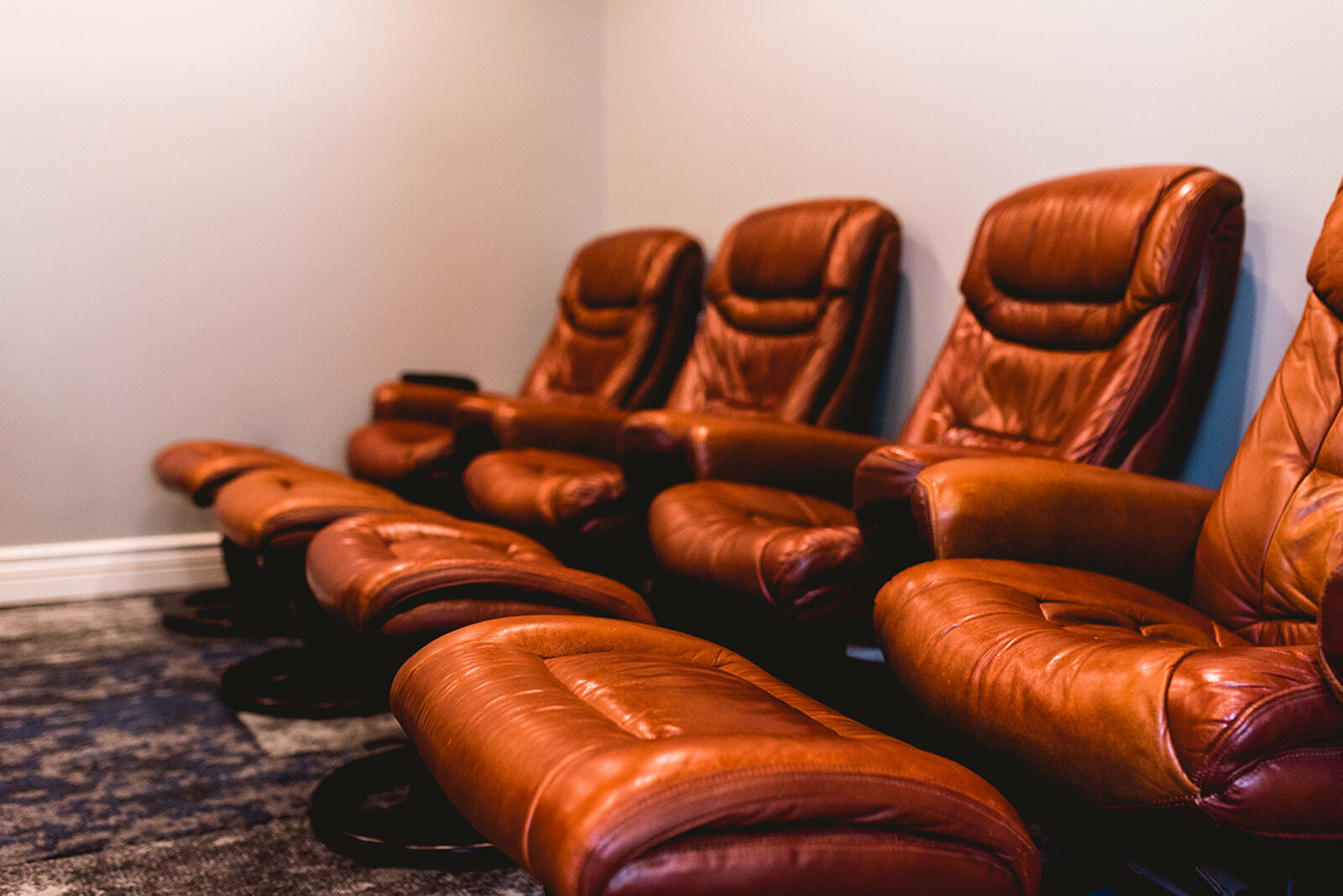 Luxurious home theater setup with plush leather recliners, perfect for ultimate relaxation and entertainment.