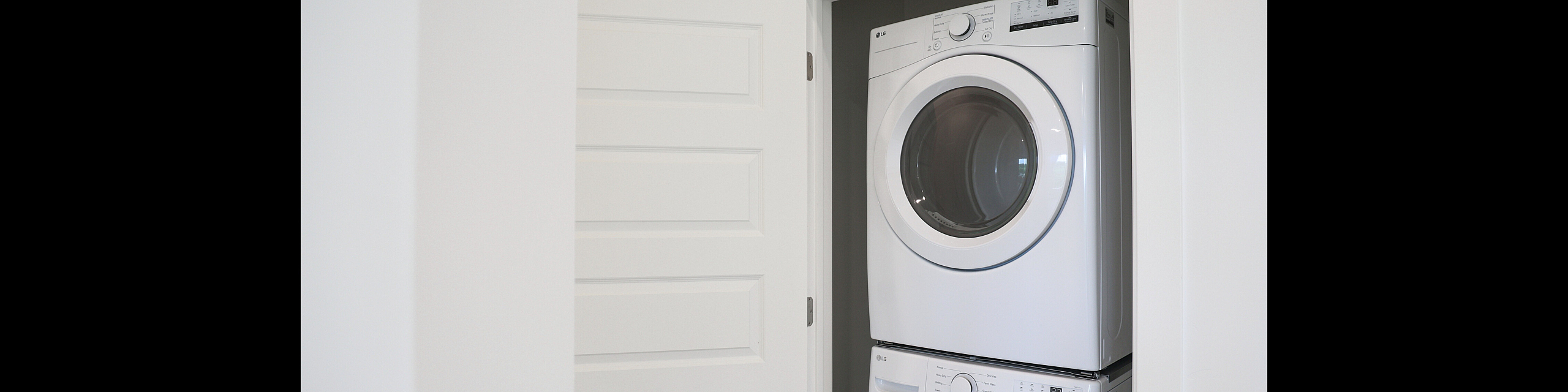 Modern apartment with a sleek stackable washer and dryer set in a convenient laundry nook.