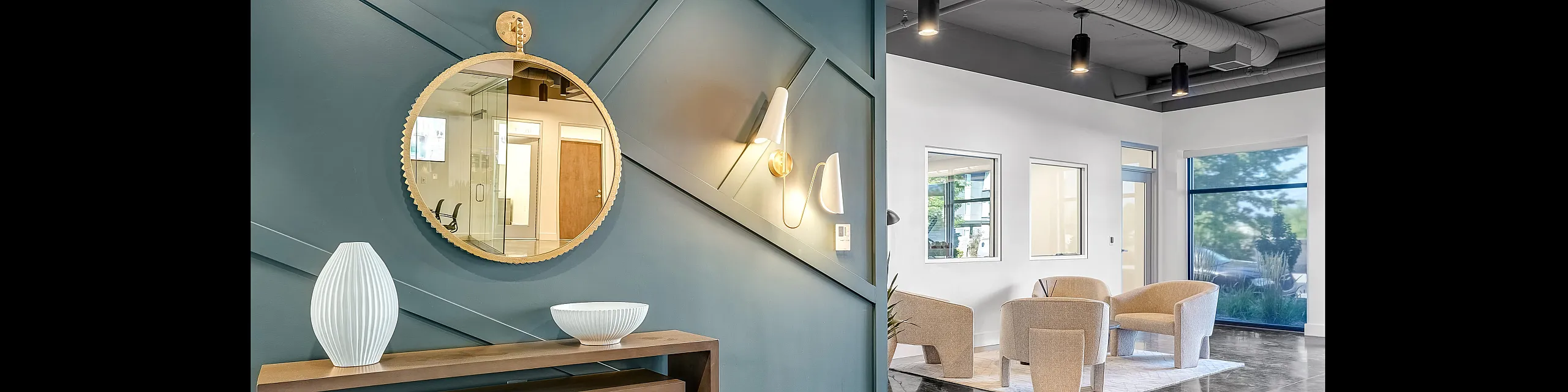 Elegant apartment lobby with modern decor, stylish seating area, and artistic wall accents.