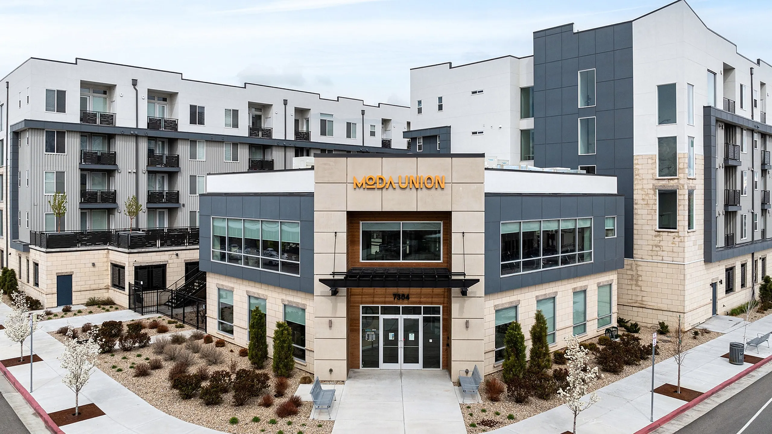 Modern apartment complex showcasing contemporary architecture with sleek lines, large windows, and inviting landscaping at Moda Union.