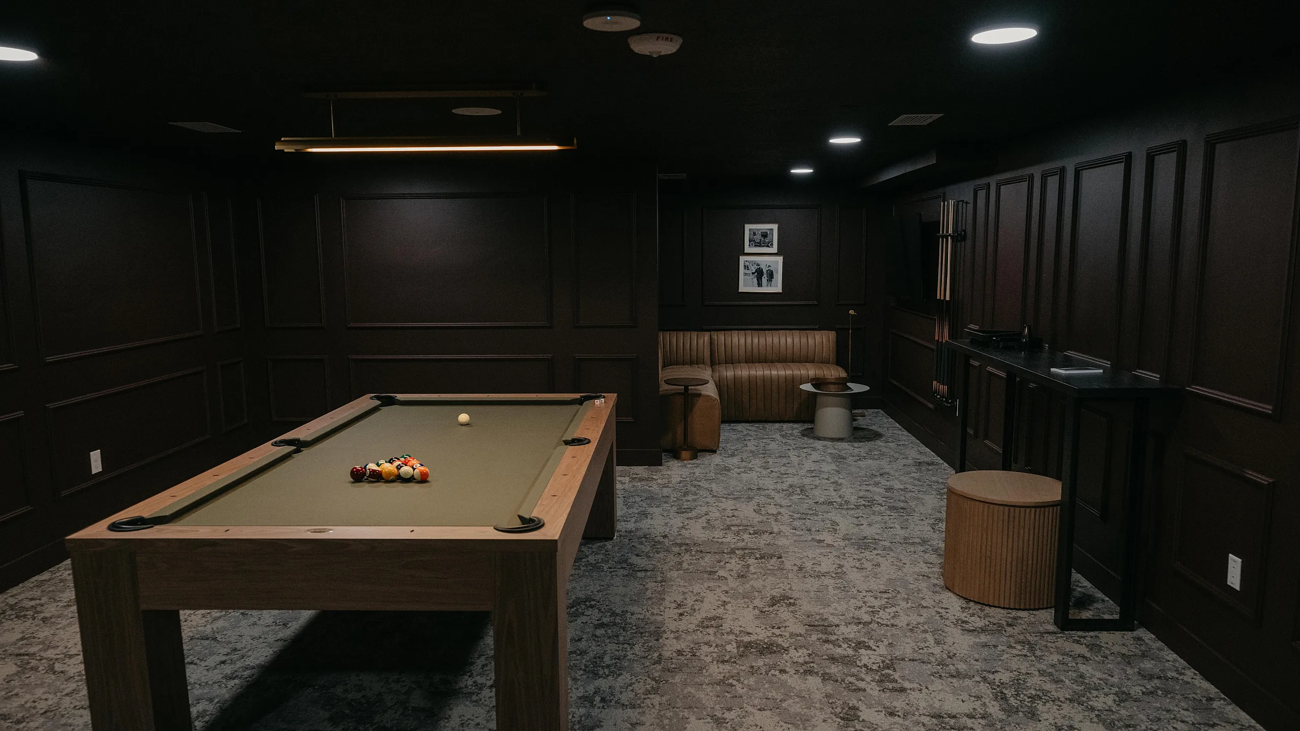 Luxurious entertainment room featuring a stylish billiards table, elegant seating, and modern lighting for a perfect game night ambiance.