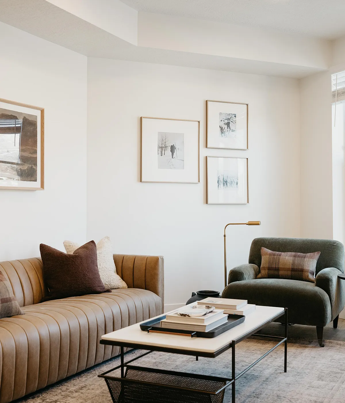 Elegant living room with a modern leather sofa, plush armchair, and stylish wall art, perfect for luxury living.