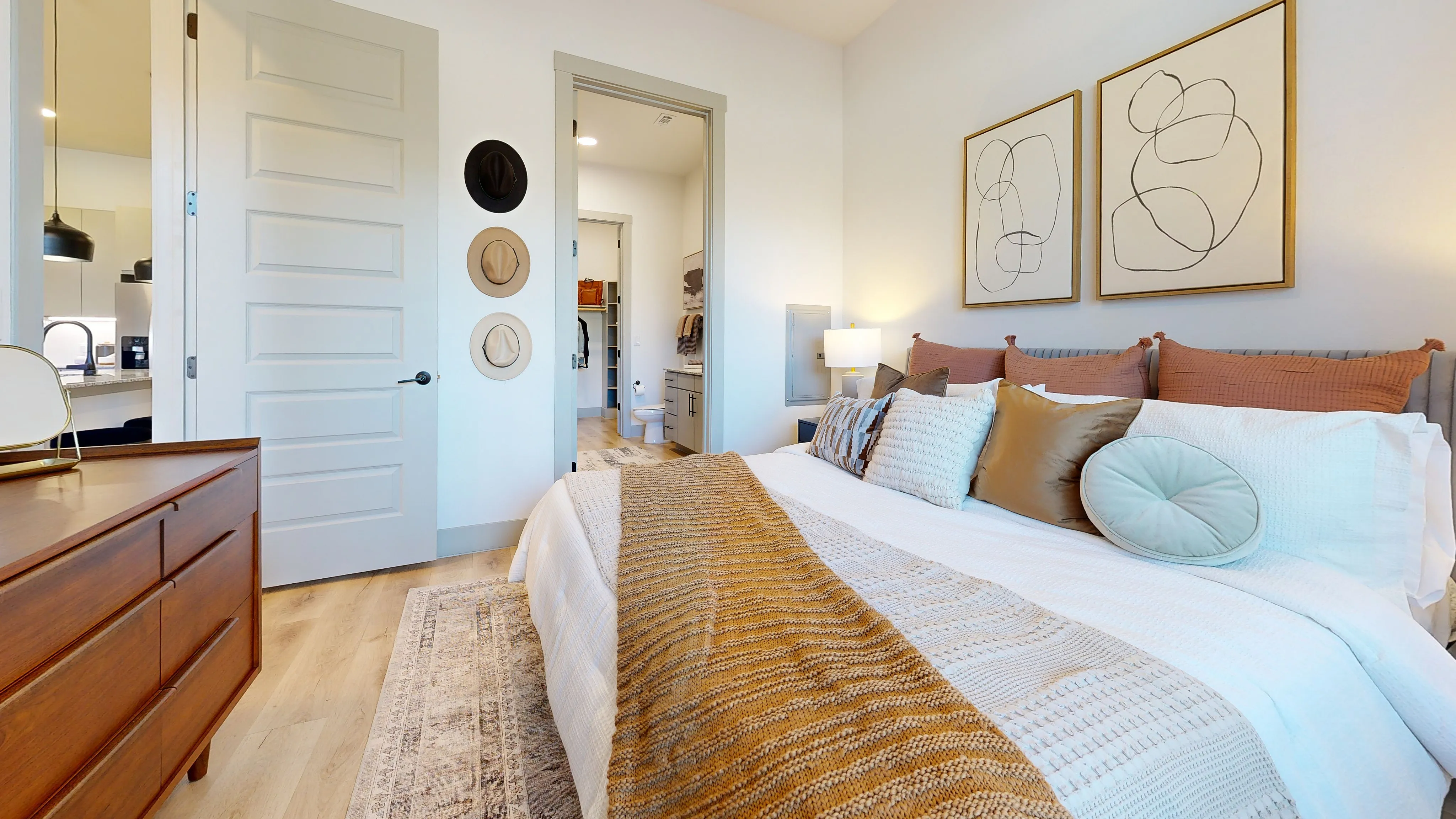 Paloma Village chic bedroom with stylish decor, cozy pillows, and a walk-in closet in a spacious Fort Worth apartment.