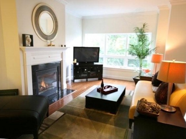 Fully furnished living room with couch and fireplace