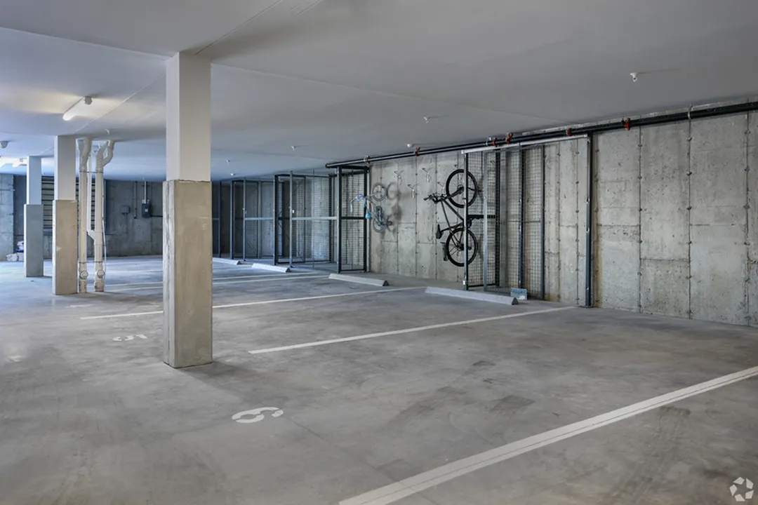 Modern underground parking garage with ample space, secure bike racks, and efficient lighting.