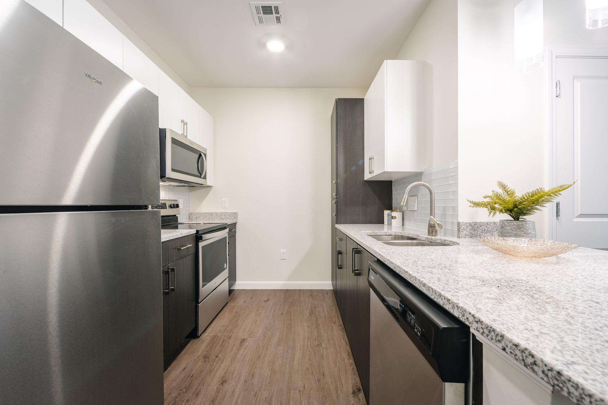 Modern kitchen with sleek stainless steel appliances, elegant granite countertops, and stylish cabinetry, offering a perfect blend of functionality and aesthetics.