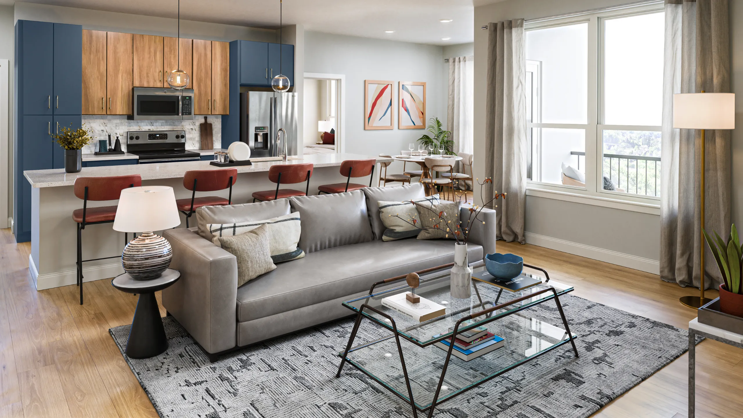 Modern open-concept living space featuring a cozy living room, stylish kitchen with wooden and blue cabinets, and a dining area filled with natural light.