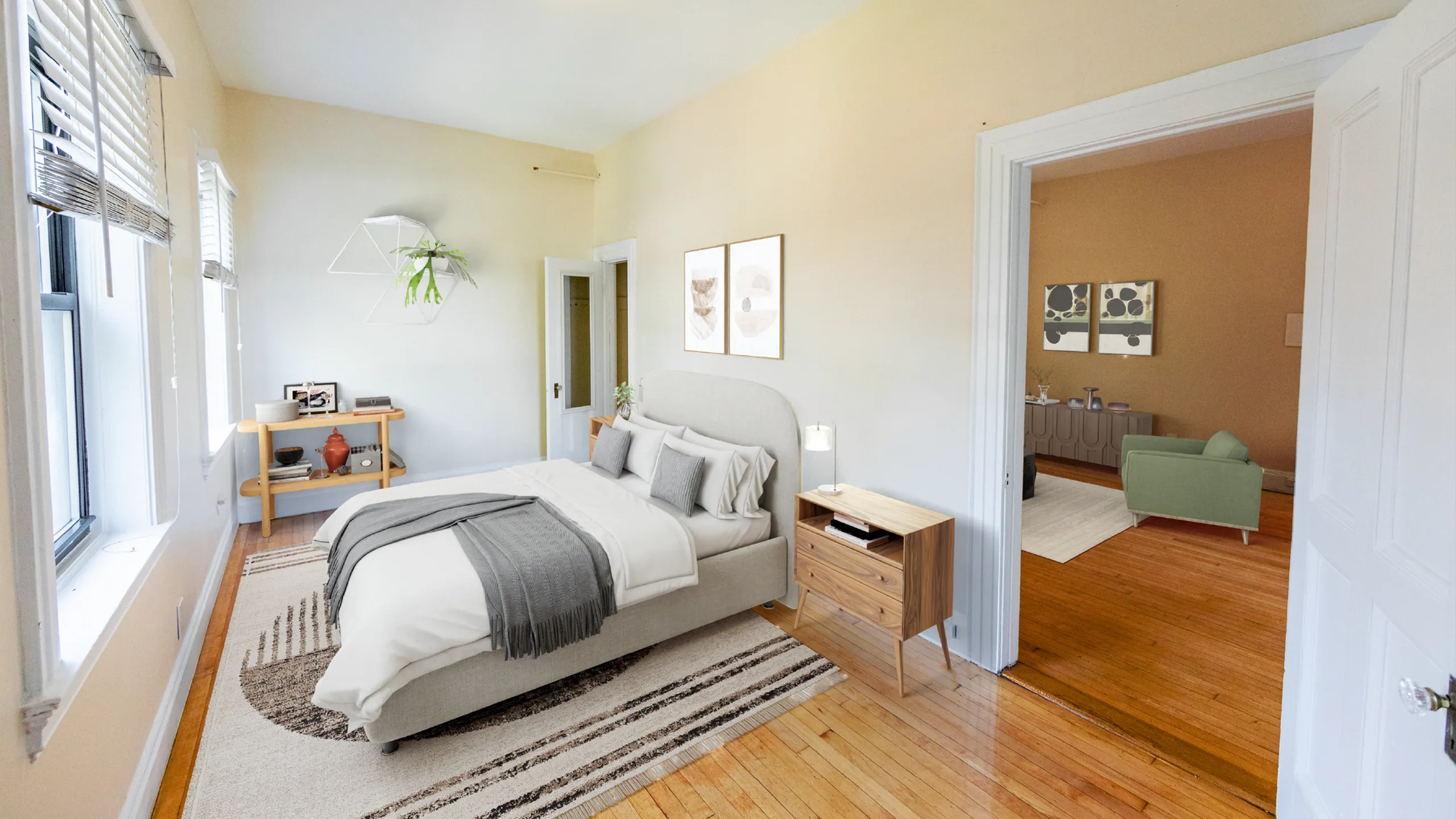 Bright, elegant bedroom with a modern design, featuring large windows, cozy bedding, and stylish wooden furniture adjoining a tastefully decorated living area.