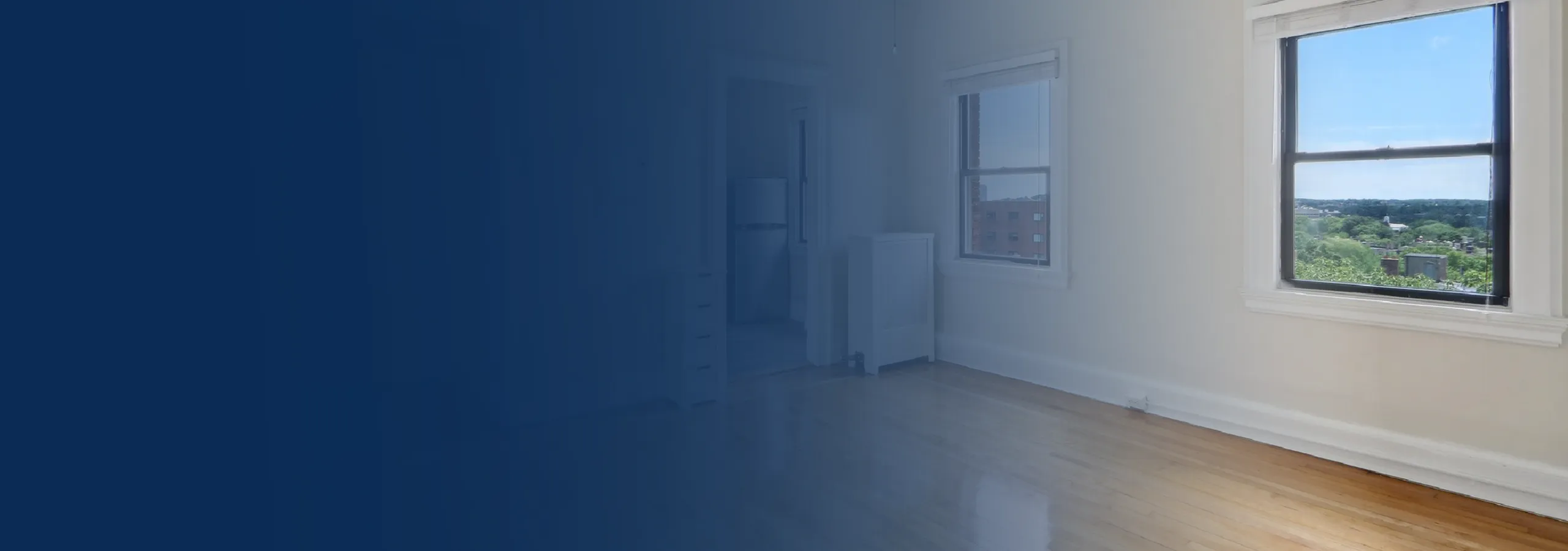 Bright apartment featuring large windows with scenic views, pristine hardwood floors, and natural light.