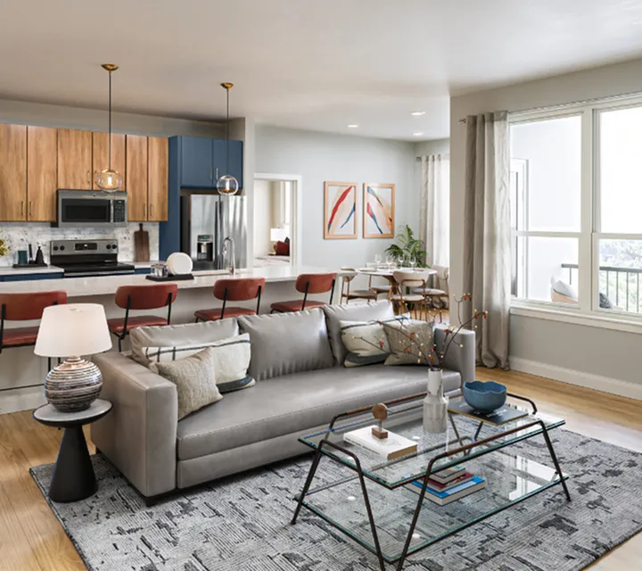 Modern open-concept living area featuring a stylish kitchen with wooden cabinets, spacious seating, and large windows for abundant natural light.