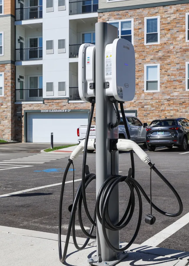 Modern apartment complex with convenient electric vehicle charging station in a stylish and sustainable design.
