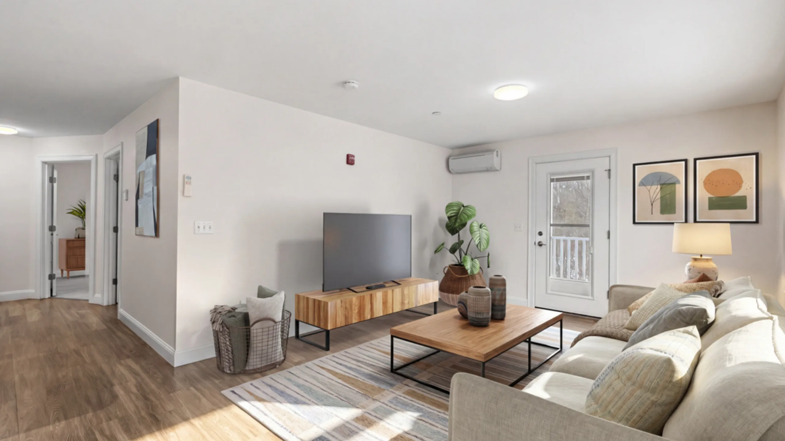 Modern living room featuring a cozy sofa, elegant wooden furniture, and chic decor, filled with natural light and a welcoming atmosphere.