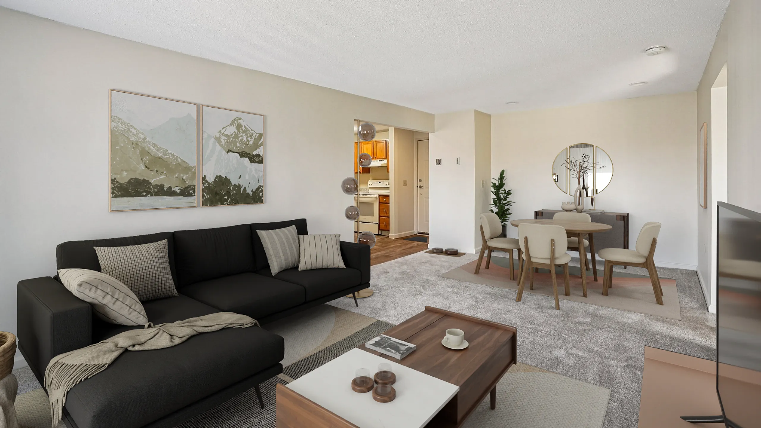 Modern living and dining area with elegant decor, black sofa, and stylish wooden table; open kitchen visible, creating a warm, inviting ambiance.