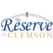 Logo for The Reserve at Clemson featuring elegant blue and orange typography with a stylized arch.