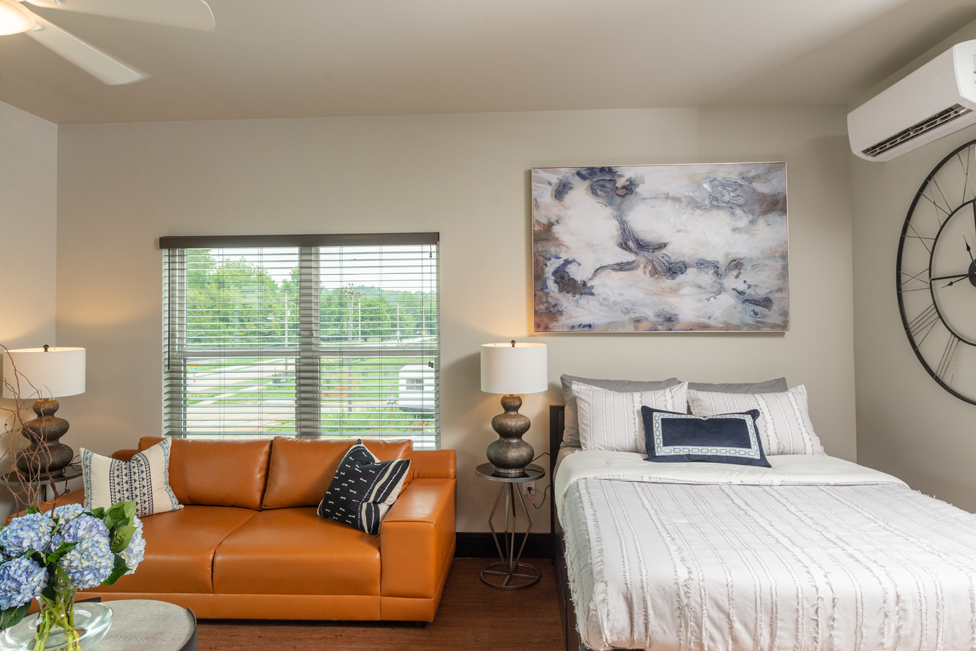 studio apartment with a kitchen, bed and couch