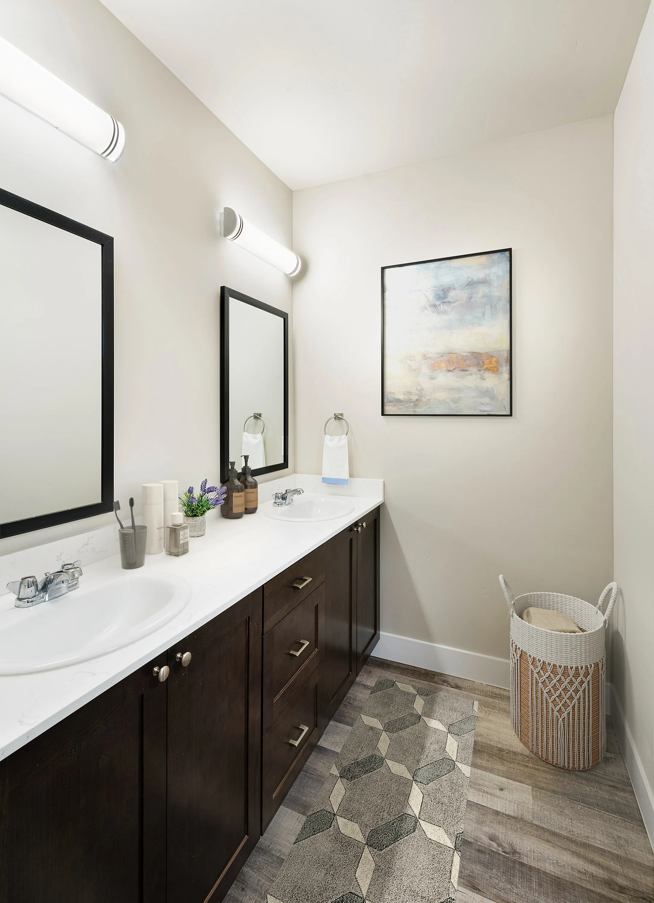 Modern bathroom interior featuring dual sinks, stylish mirrors, and contemporary décor.