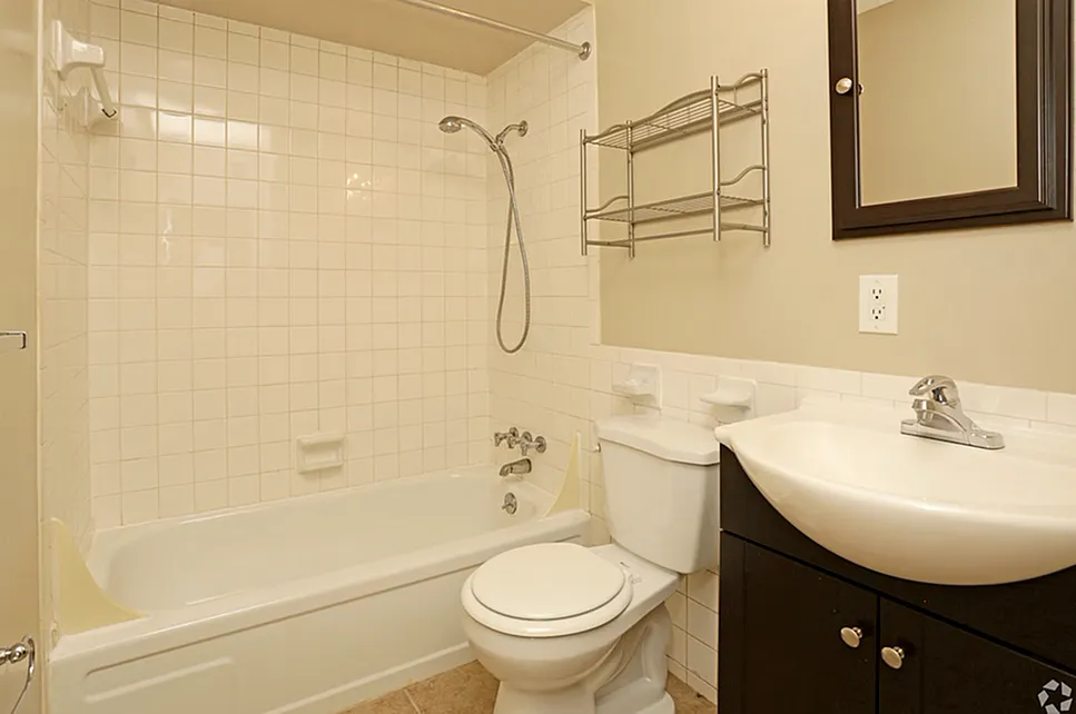 Inviting bathroom with a sleek white bathtub, modern amenities, and elegant storage solutions.
