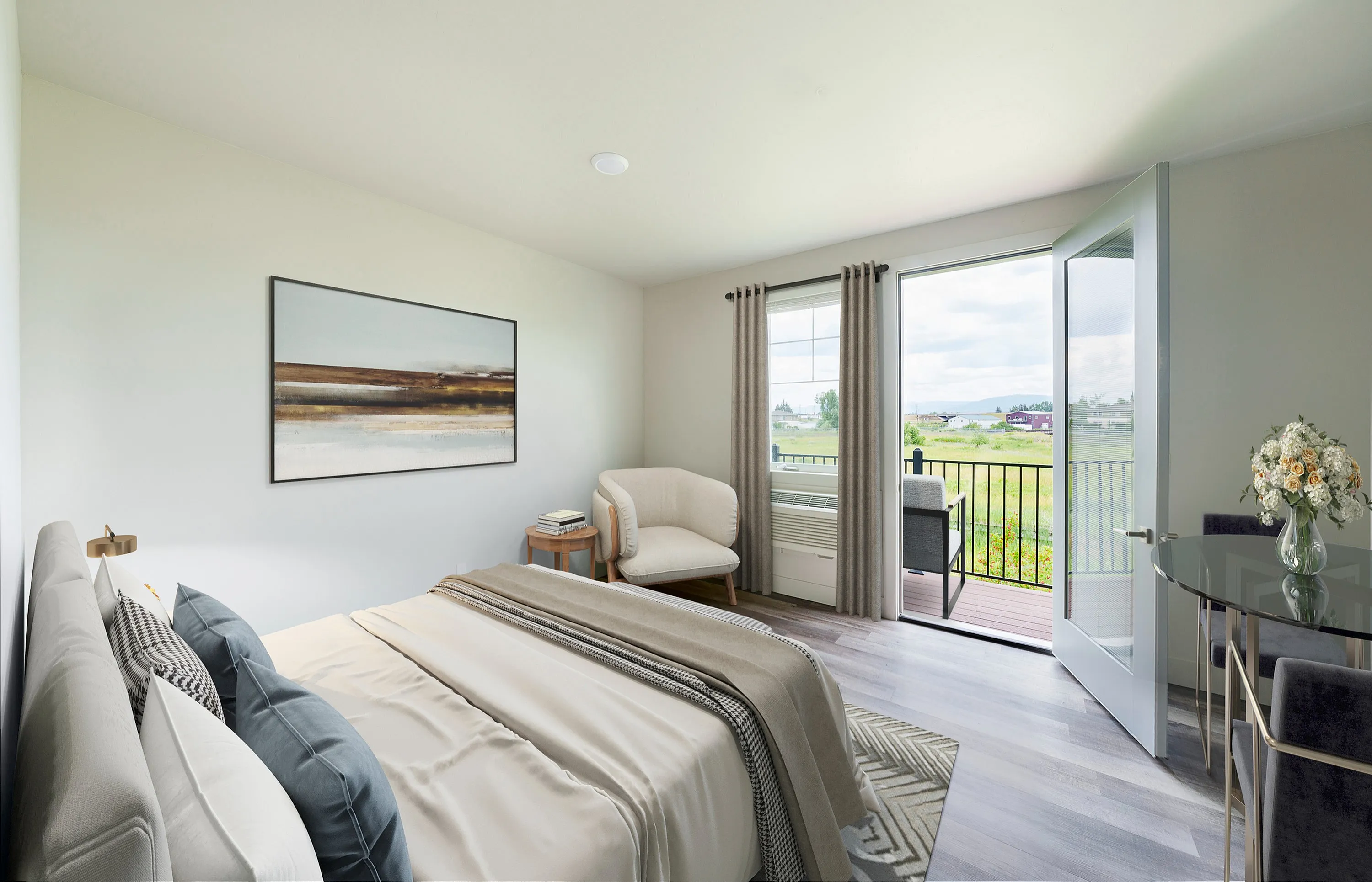 Inviting bedroom with elegant decor, large glass doors opening to a balcony with scenic views, and stylish furnishings for a relaxing retreat.