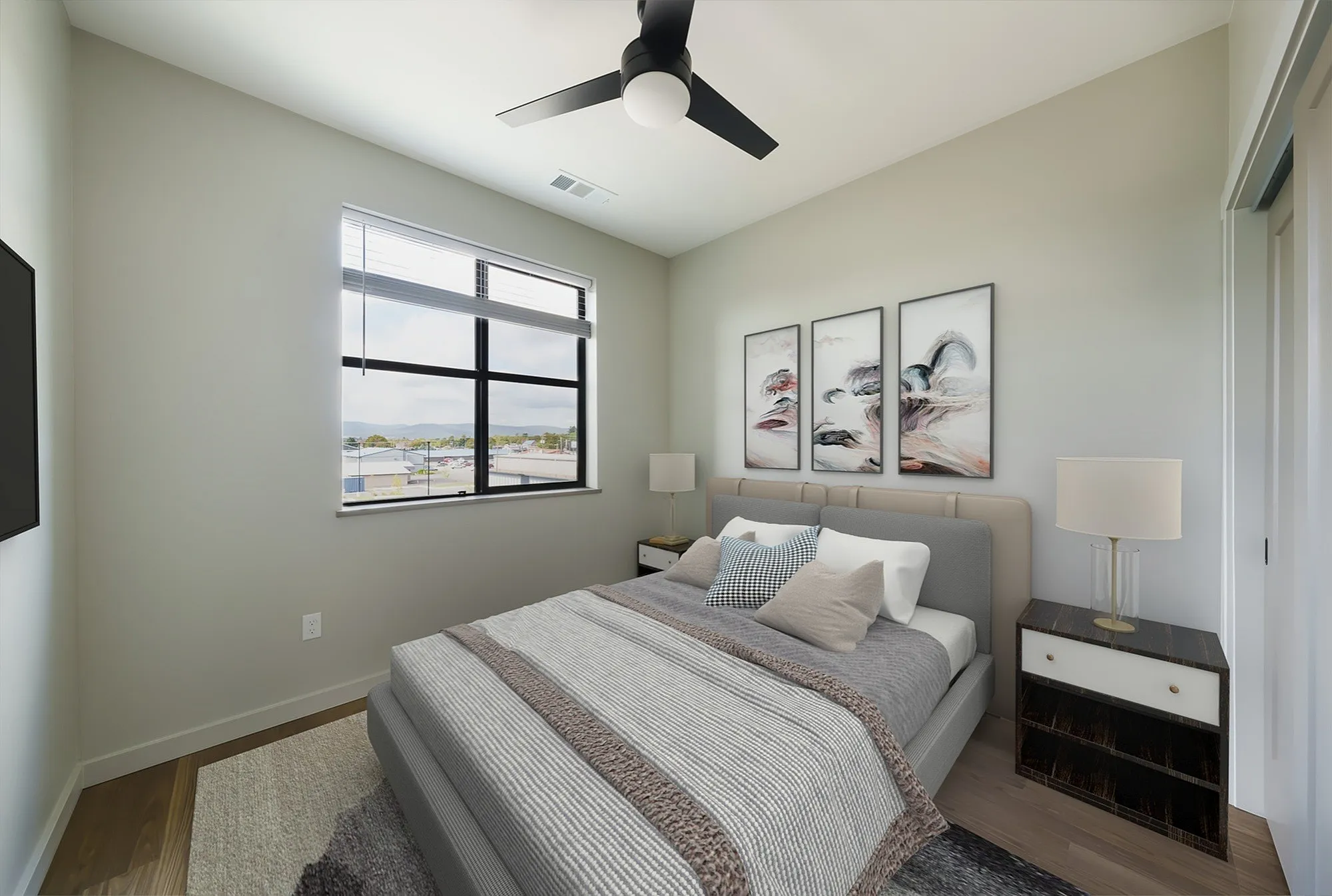 Inviting bedroom with contemporary decor, featuring a large window with scenic views, cozy bed, and stylish artwork.
