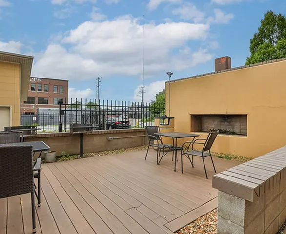Inviting outdoor patio with modern fireplace, stylish seating, and urban views, perfect for entertaining and relaxation.
