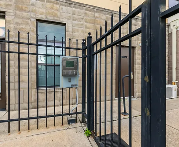 Secure gated entrance with keyless entry system in a modern apartment complex.