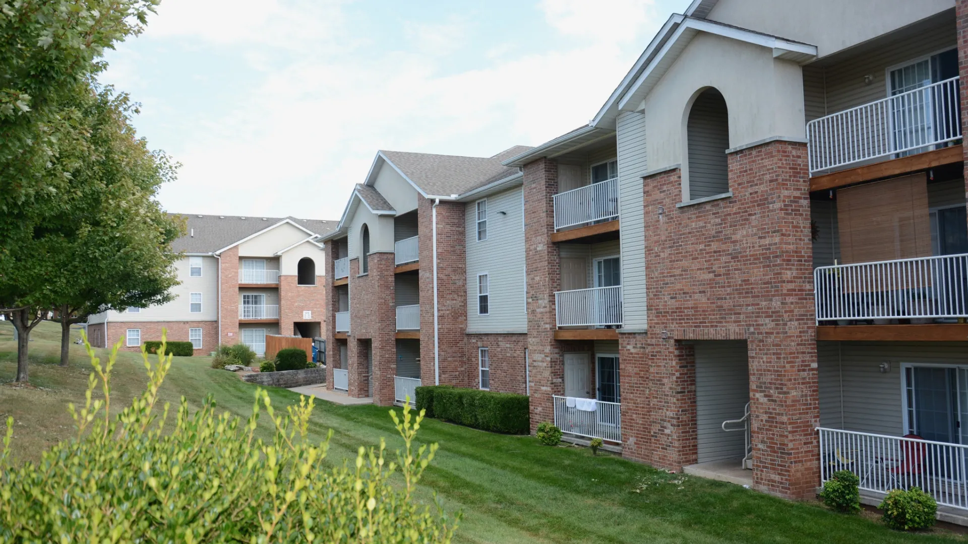 Quail Creek Apartments exterior building with siding and brick