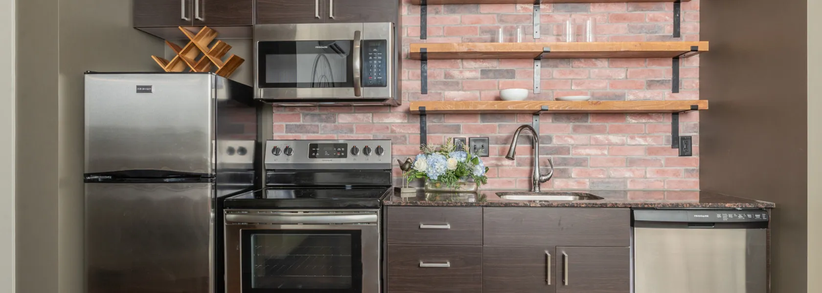 kitchen with brick accent wall at Galloway Creek apartments in Springfield, MO