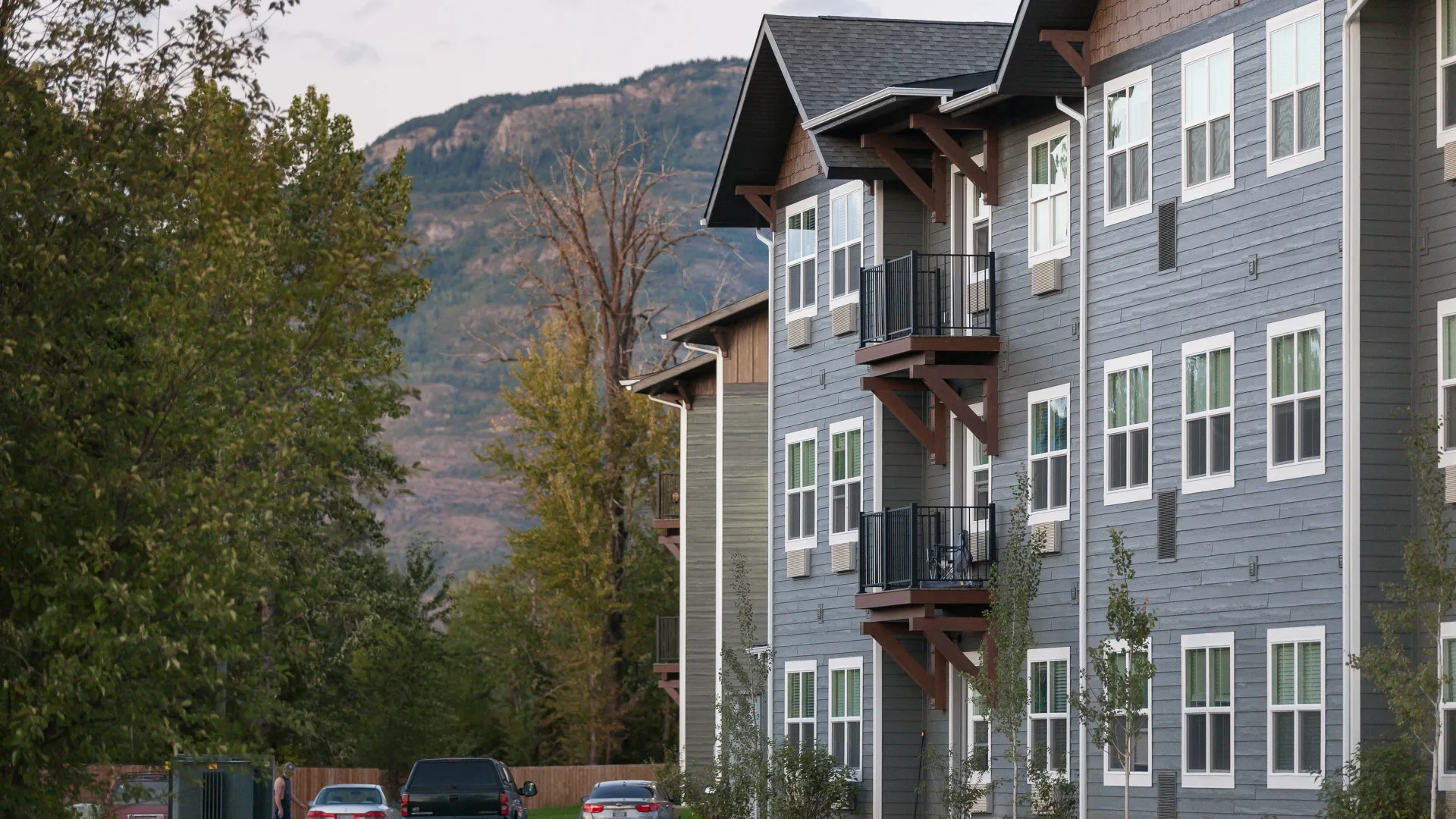 Highline Apartments exterior blue building overlooking mountains in Montana