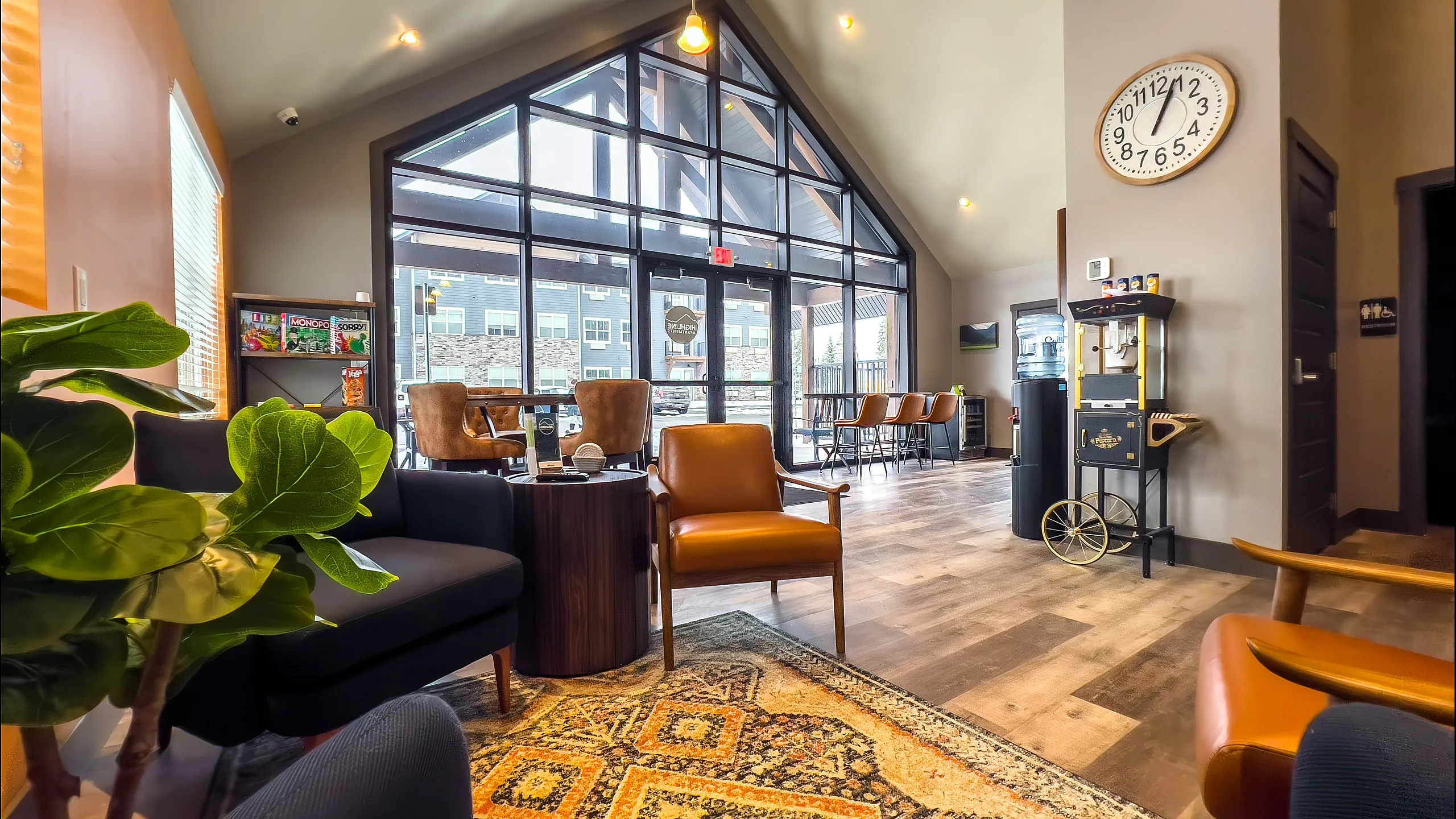 Inviting lounge area with comfortable seating, large windows, and stylish decor featuring a blend of modern and rustic elements.