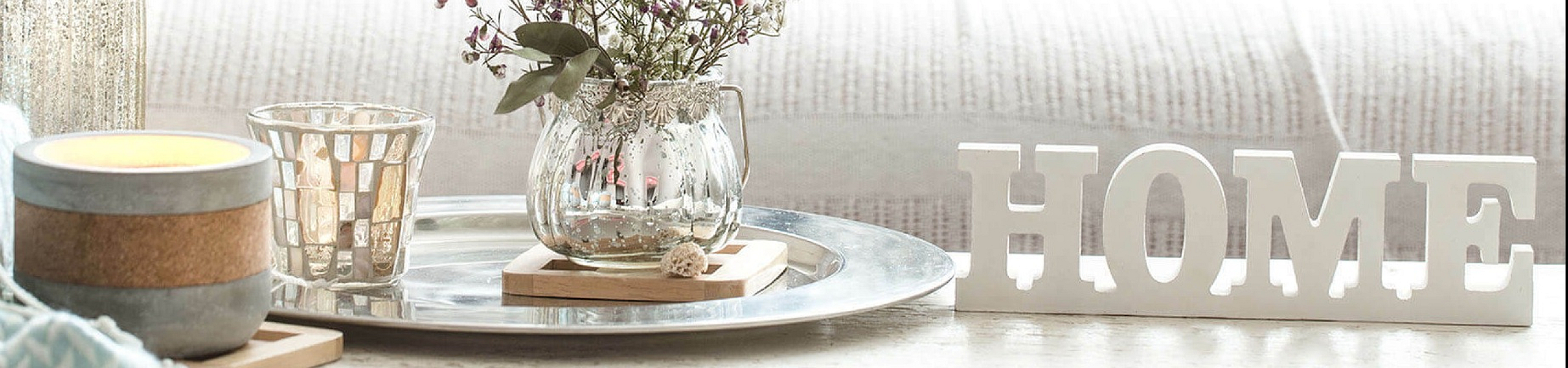 Chic living space with cozy cushions, a stylish floral arrangement, and elegant decor for a welcoming home atmosphere.
