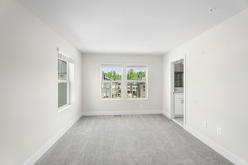 The Current at Watershed bedroom with carpet and two windows - Laurel, MD
