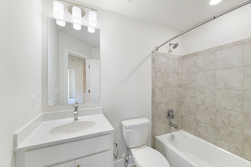 The Current at Watershed bathroom with tub and vanity mirror - Laurel, MD