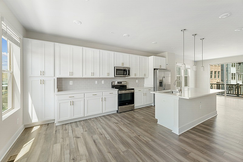 The Current at Watershed kitchen with island and stainless steel appliances - Laurel, MD