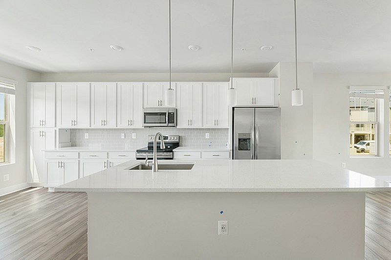 The Current at Watershed kitchen with island and stainless steel appliances - Laurel, MD
