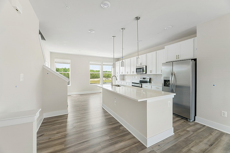 The Current at Watershed kitchen with island and stainless steel appliances - Laurel, MD