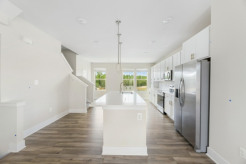 The Current at Watershed kitchen with island and stainless steel appliances - Laurel, MD
