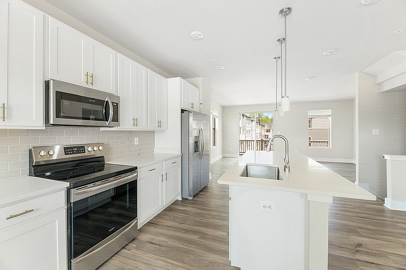 The Current at Watershed kitchen with island and stainless steel appliances - Laurel, MD