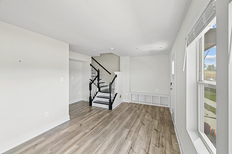 The Current at Watershed living room with staircase and windows - Laurel, MD