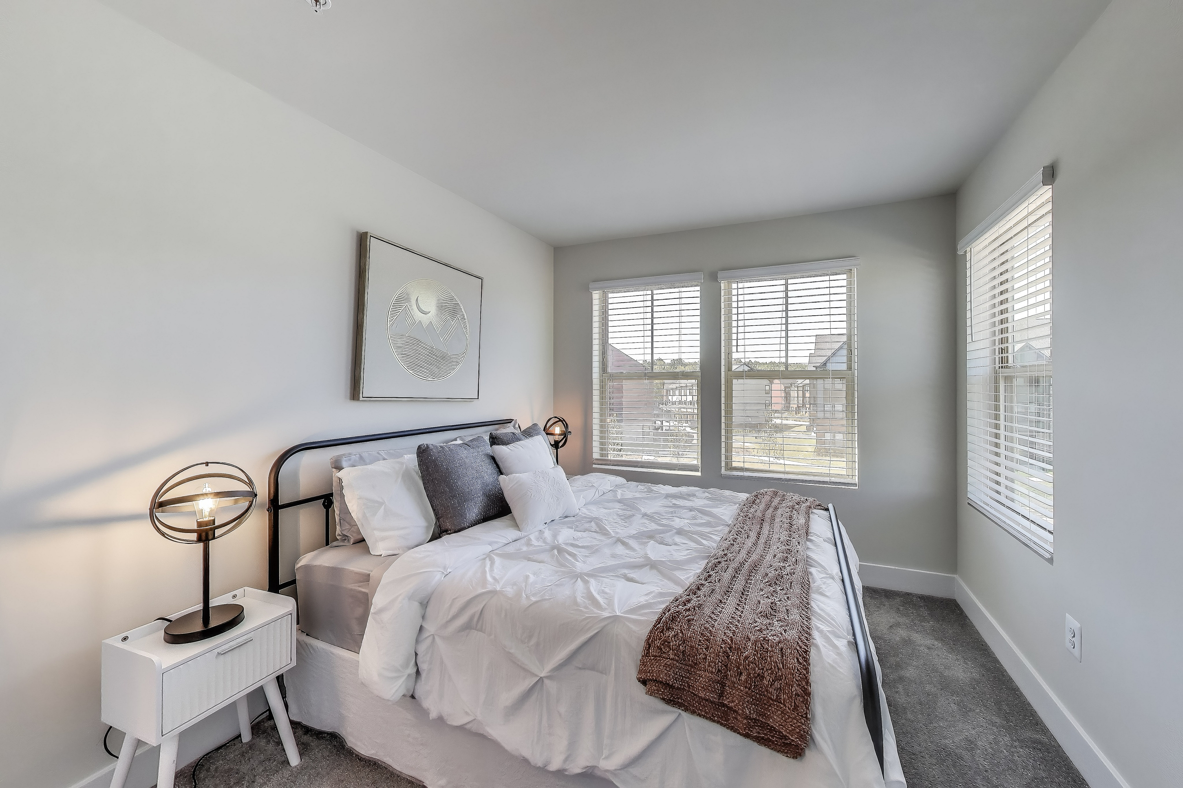The Current at Watershed bedroom with bed and multiple windows - Laurel, MD