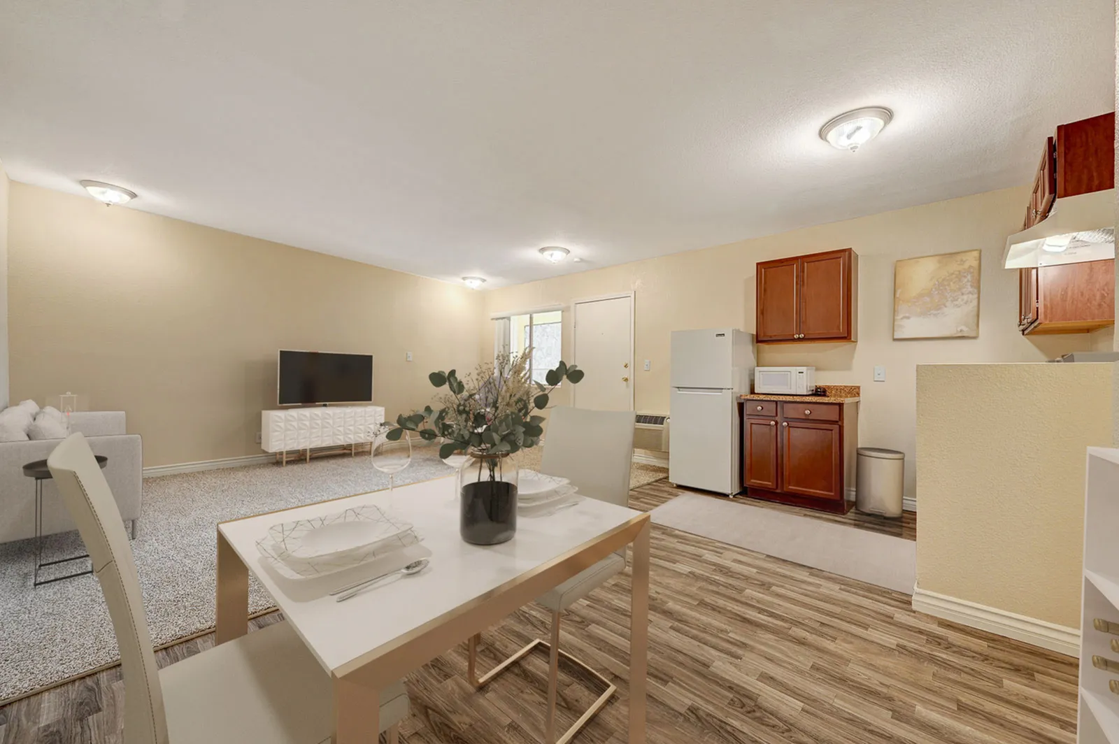 Modern open-plan living area with cozy seating, dining set, and compact kitchen.