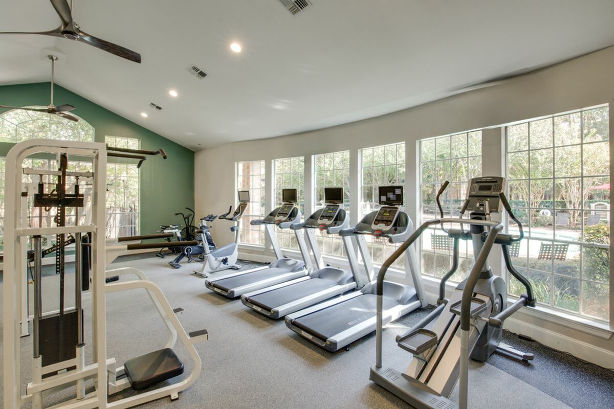 View of Fitness Center with Ceiling Fan,and Cardio Machines, at Raveneaux Apartments