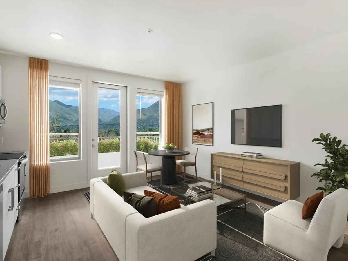 Contemporary living room at The Richmond with large windows, Wasatch Mountain view, and stylish furniture.