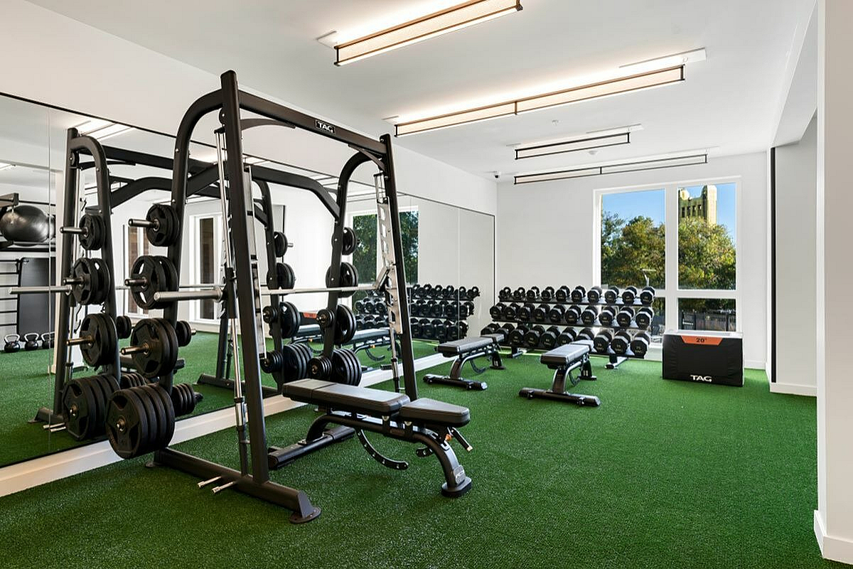 Spacious modern gym with weight equipment and large windows for natural light at 805 Riverfront in Sacramento with City View
