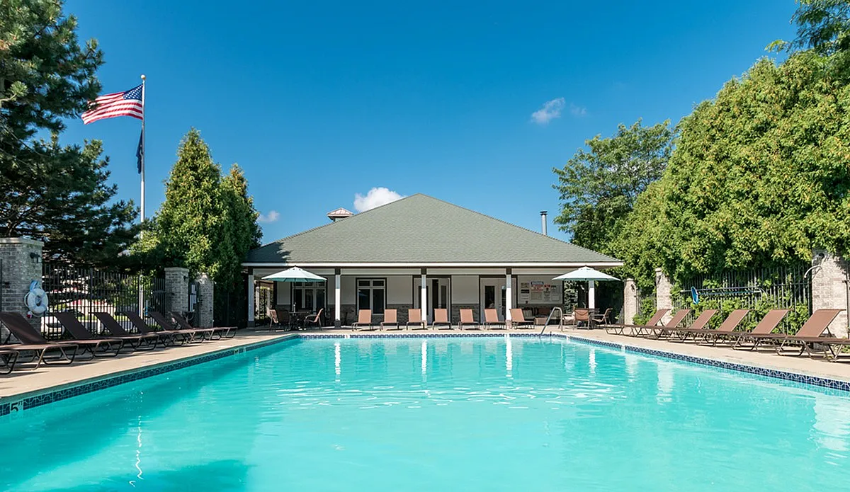 View of Resort-Style Pool, Showing Clubhouse Exterior, Lounge Chairs, Landscaping at Clearview Apartments