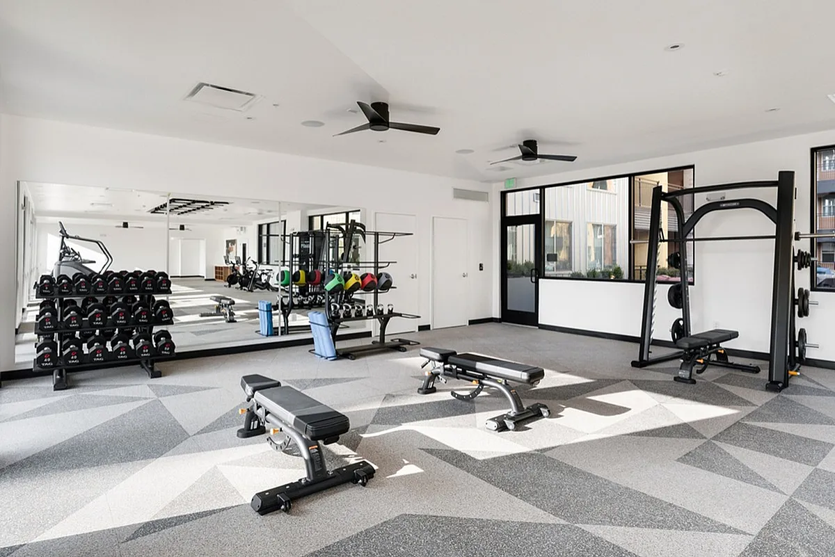 Modern fitness center at Cottonwood Highland with sleek equipment and spacious mirrored walls for an invigorating workout experience.