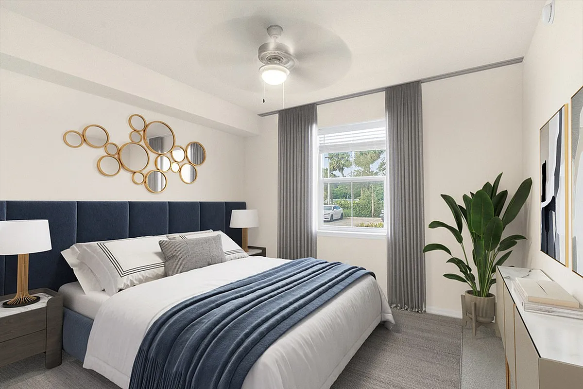 Elegant bedroom at Cottonwood Lighthouse Point Apartments with plush navy headboard, modern decor, and natural light streaming through a large window.