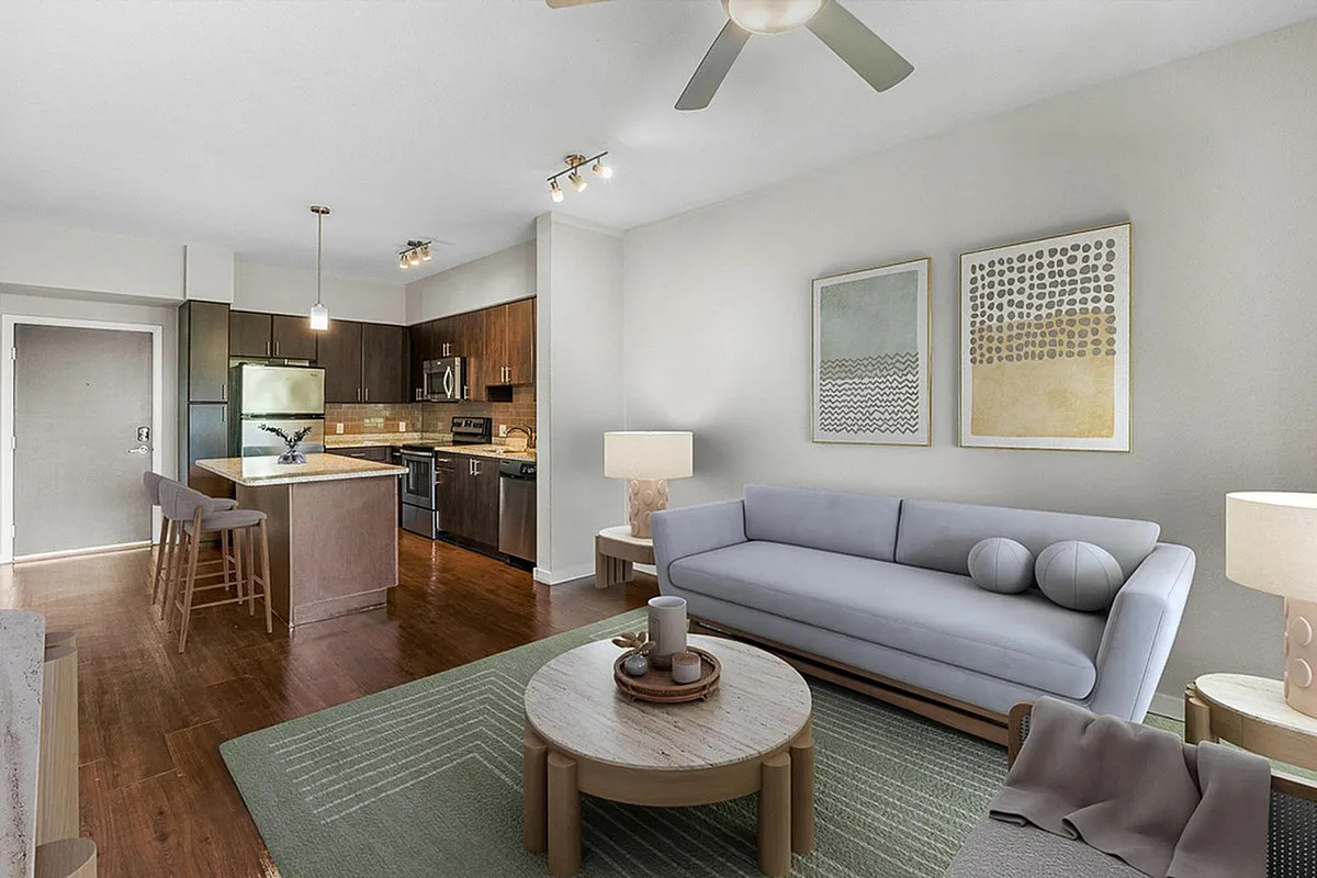 Modern open-plan living area with stylish kitchen, elegant light fixtures, and cozy seating. A perfect blend of comfort and sophistication.