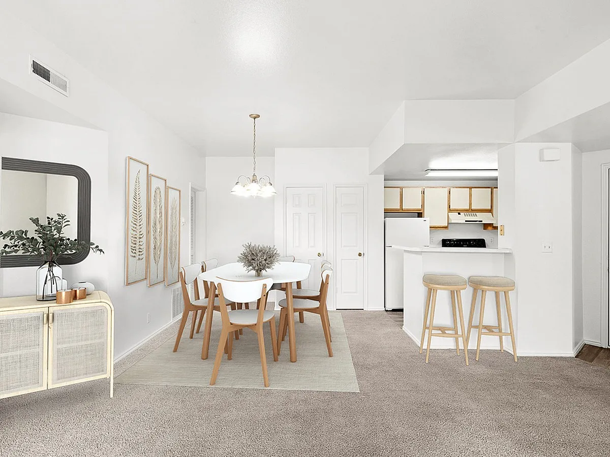 Bright and inviting living space with modern dining area, stylish kitchen, and tasteful decor at Fox Point Apartments.