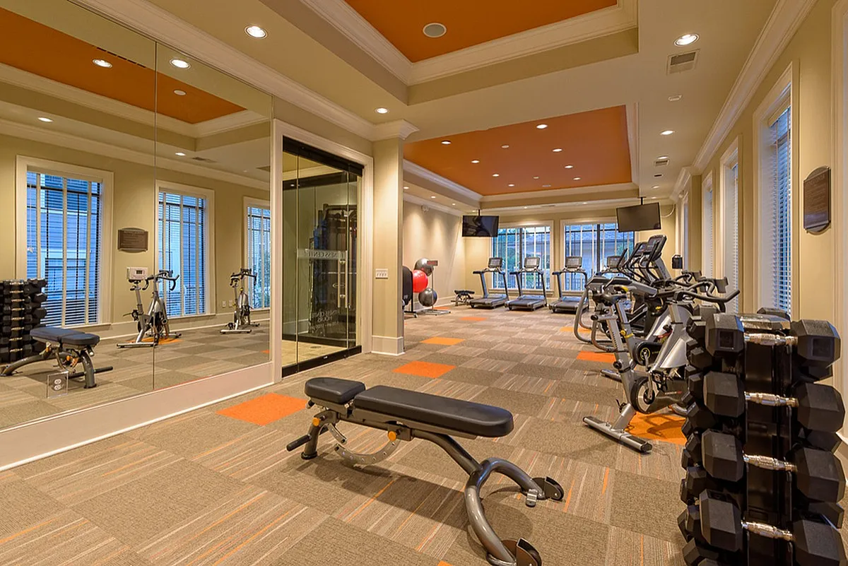 Spacious modern fitness center at Heights at Meridian Apartments with state-of-the-art gym equipment and natural light.