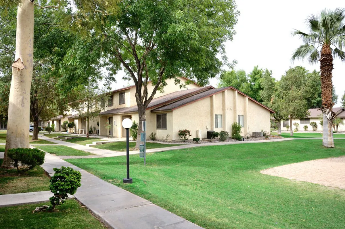Charming apartment complex surrounded by lush greenery and well-maintained pathways, offering a tranquil living environment at Camelot Apartments in Yuma AZ